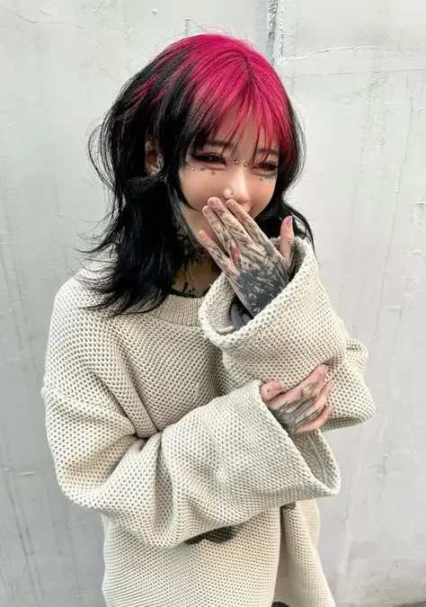 Black choppy wolf cut with hot pink ghost roots through the fringe and crown.