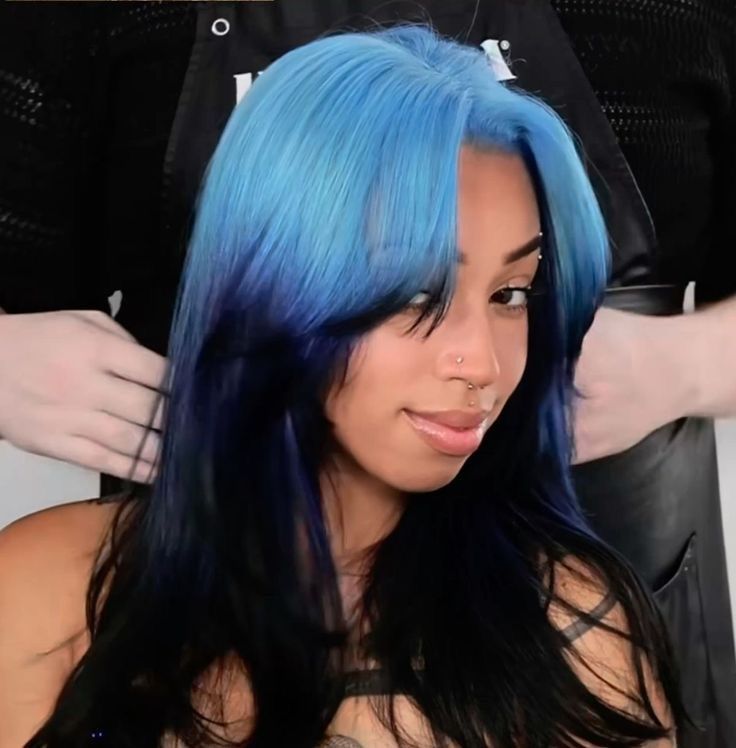 Black layered hair with pastel sky-blue ghost roots and long curtain pieces.