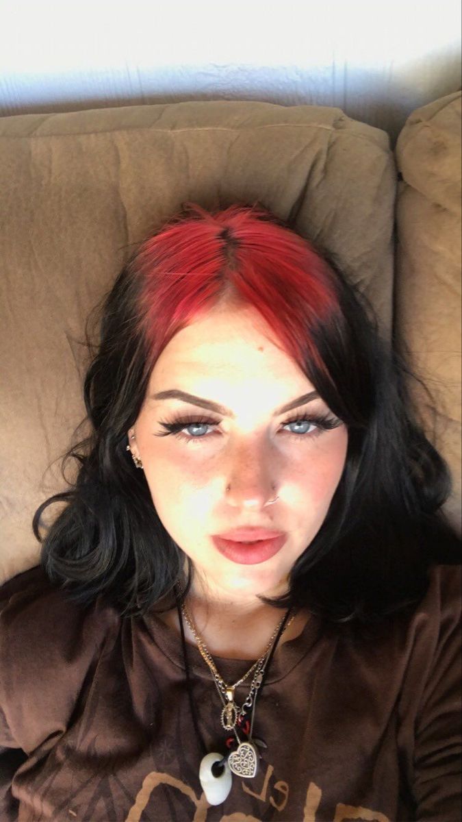 Soft black bob with crimson red ghost roots and a center-part shape.