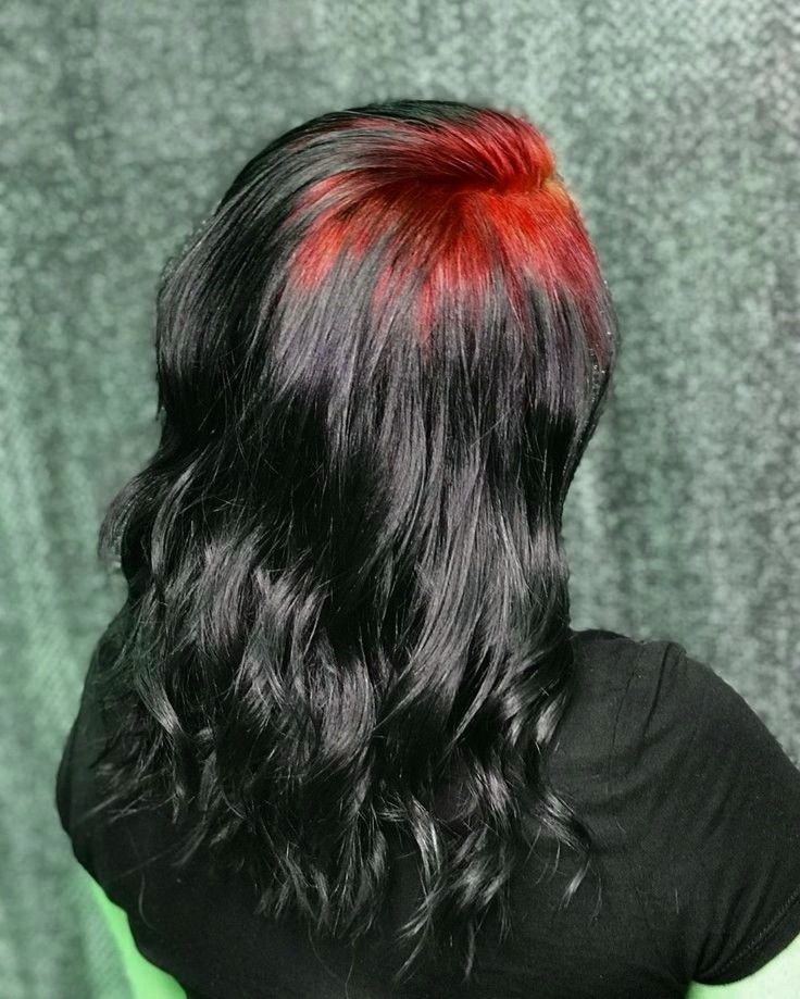 Long black waves with bright red ghost roots concentrated across the crown.