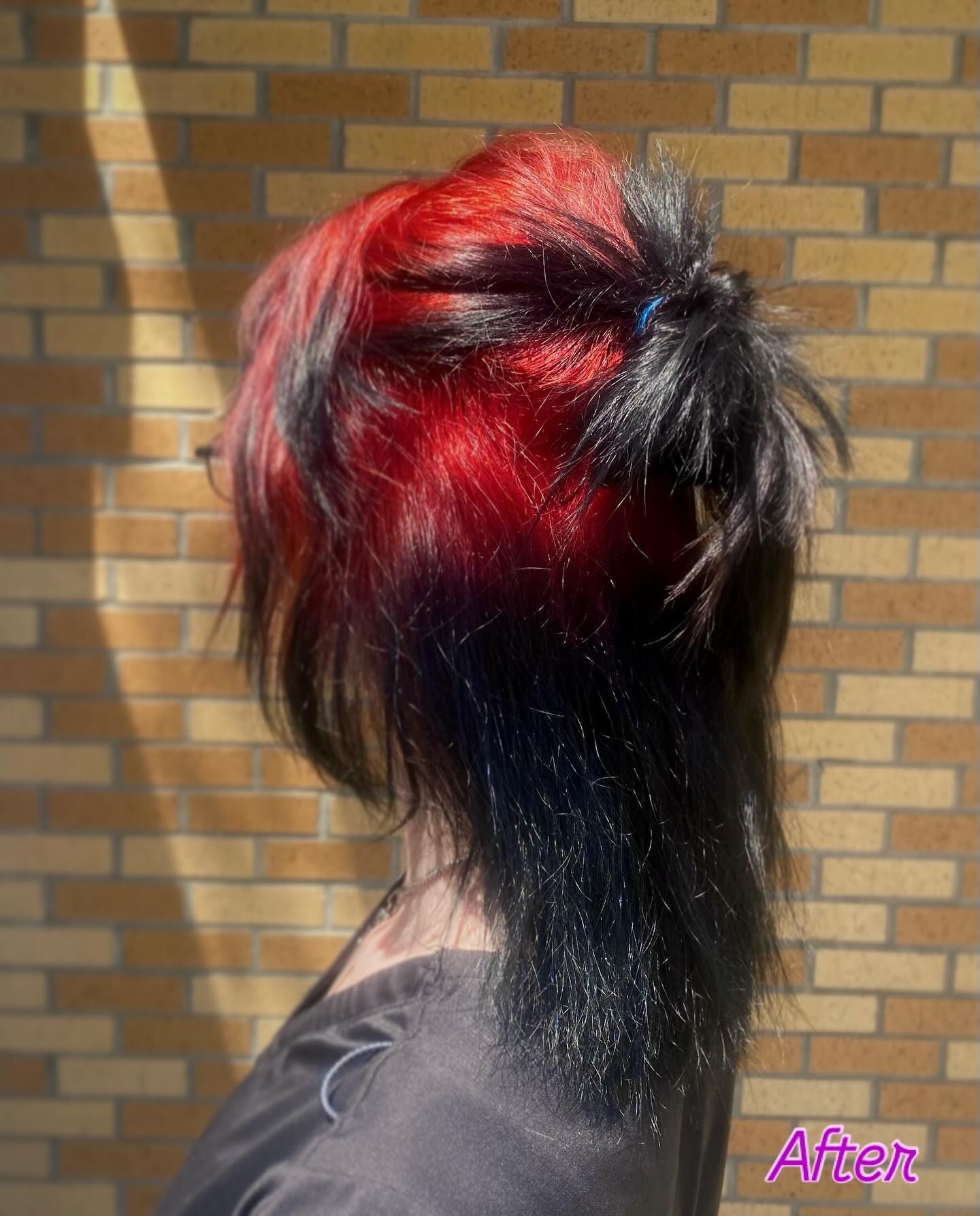 Half-up black hair with cherry red ghost roots through the crown.