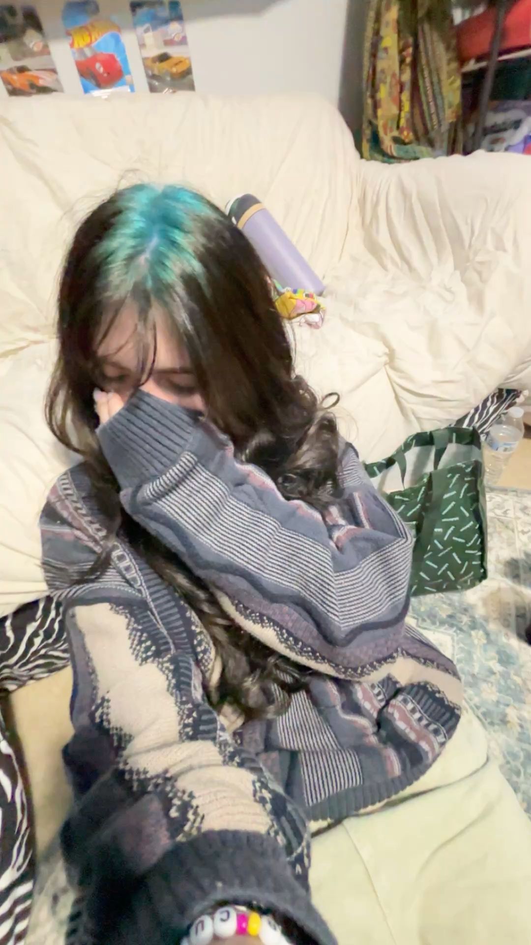 Long dark brown waves with turquoise ghost roots through the center part.