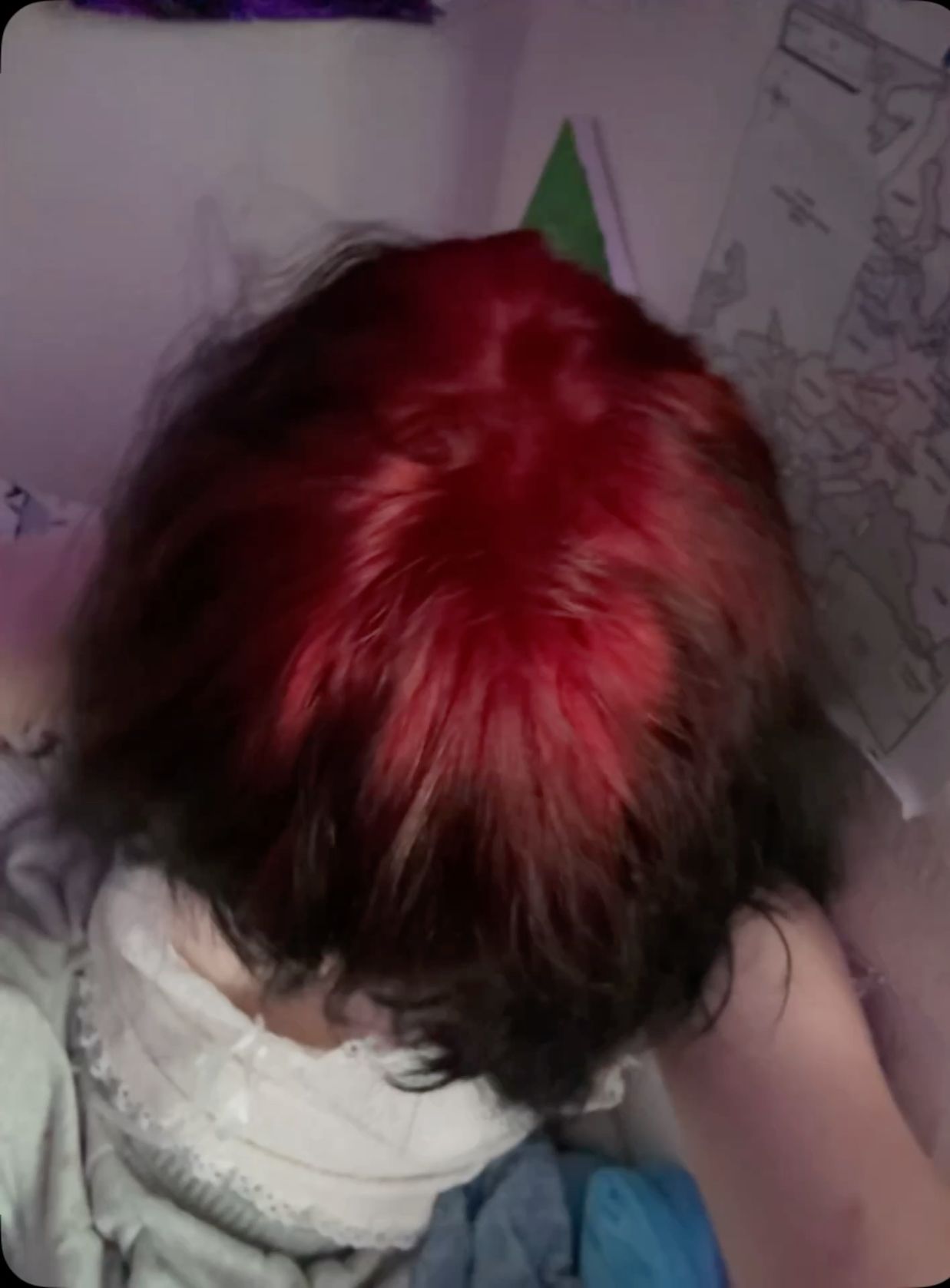 Short dark bob with a saturated red ghost-root panel across the crown.