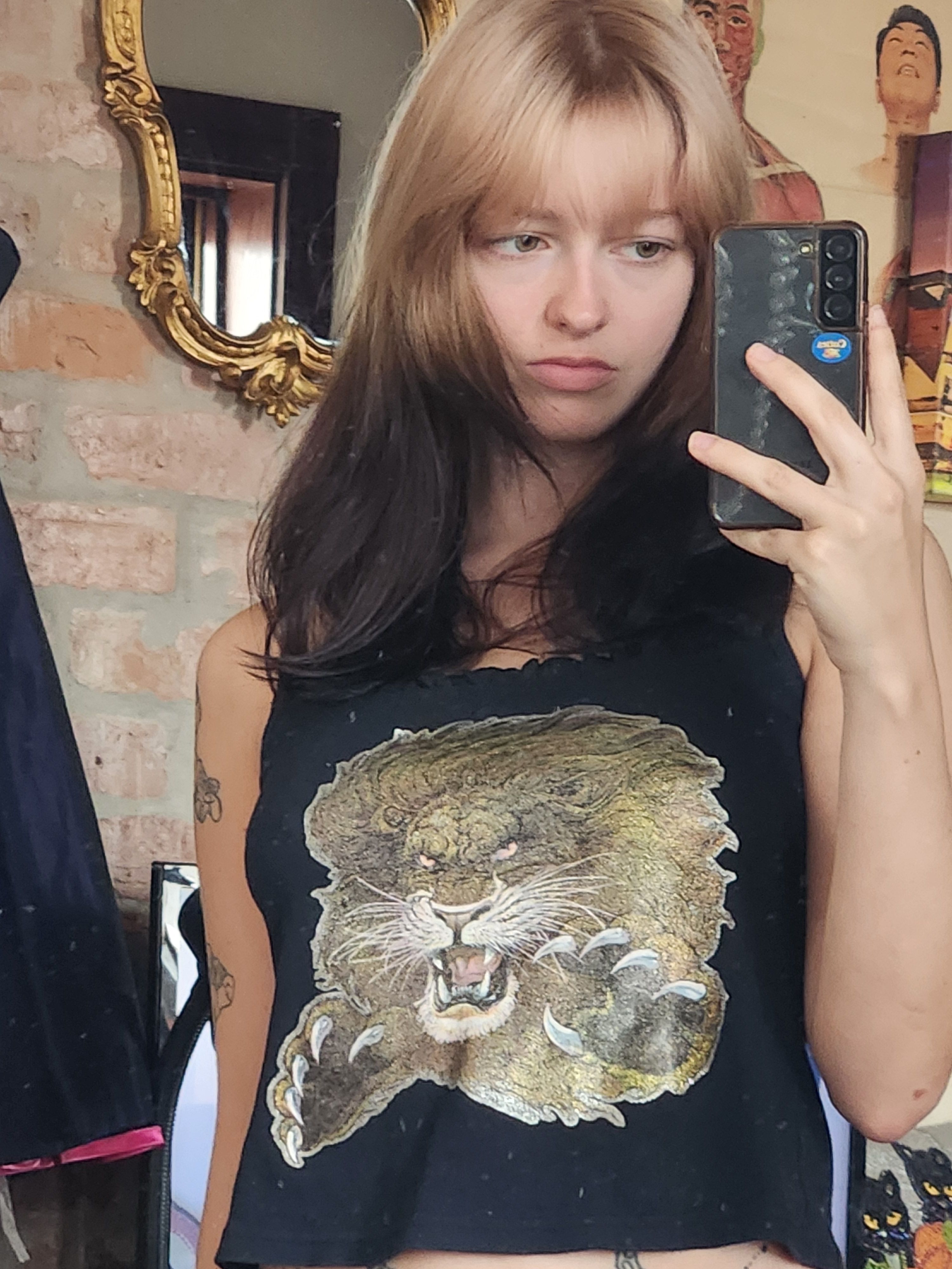 Dark brown shoulder-length hair with soft beige blonde ghost roots and curtain bangs.