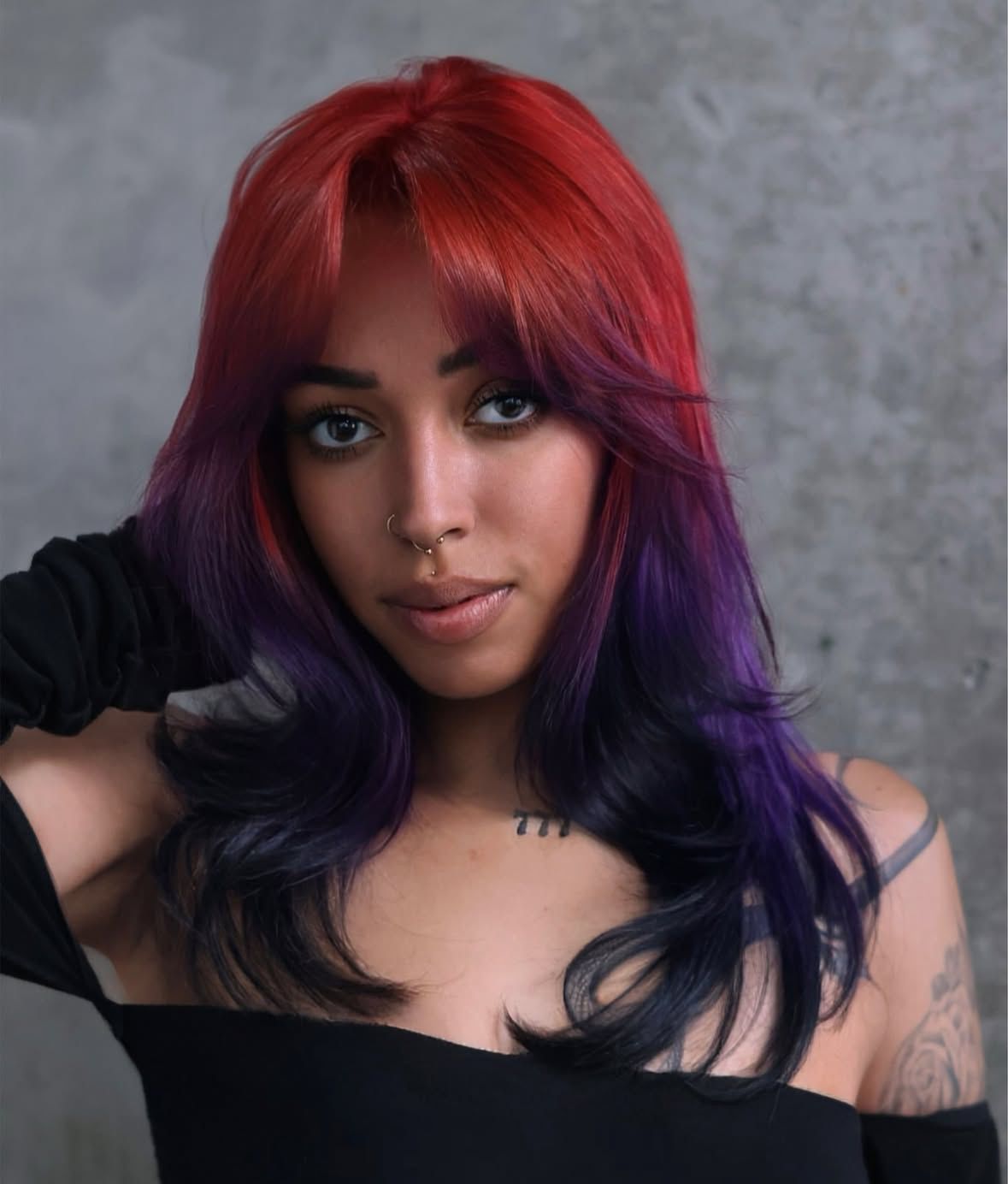 Layered shoulder-length hair with red ghost roots fading into violet and dark indigo ends.