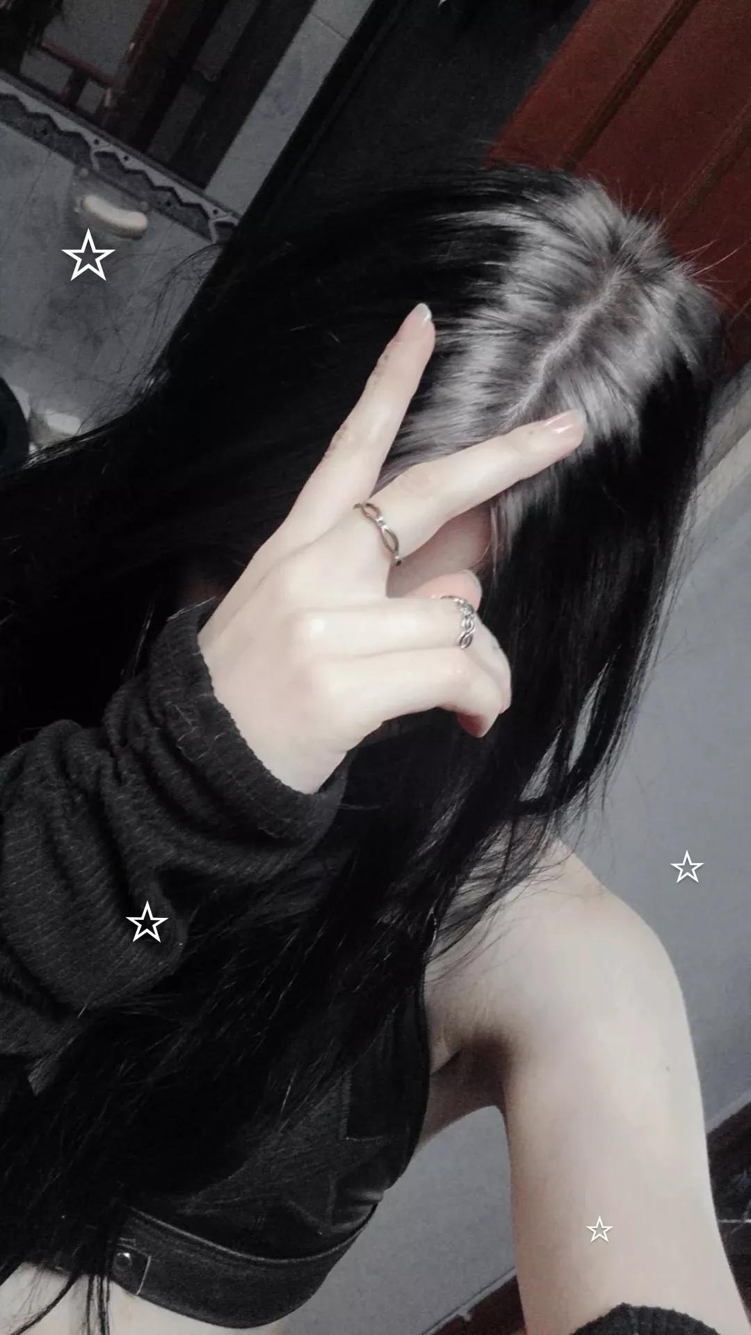 Long black hair with a subtle smoky silver ghost root at the center part.