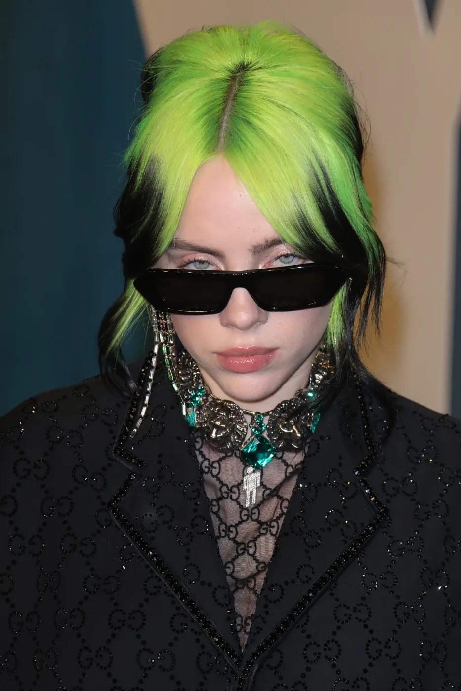 Black updo with neon chartreuse ghost roots and face-framing front pieces.