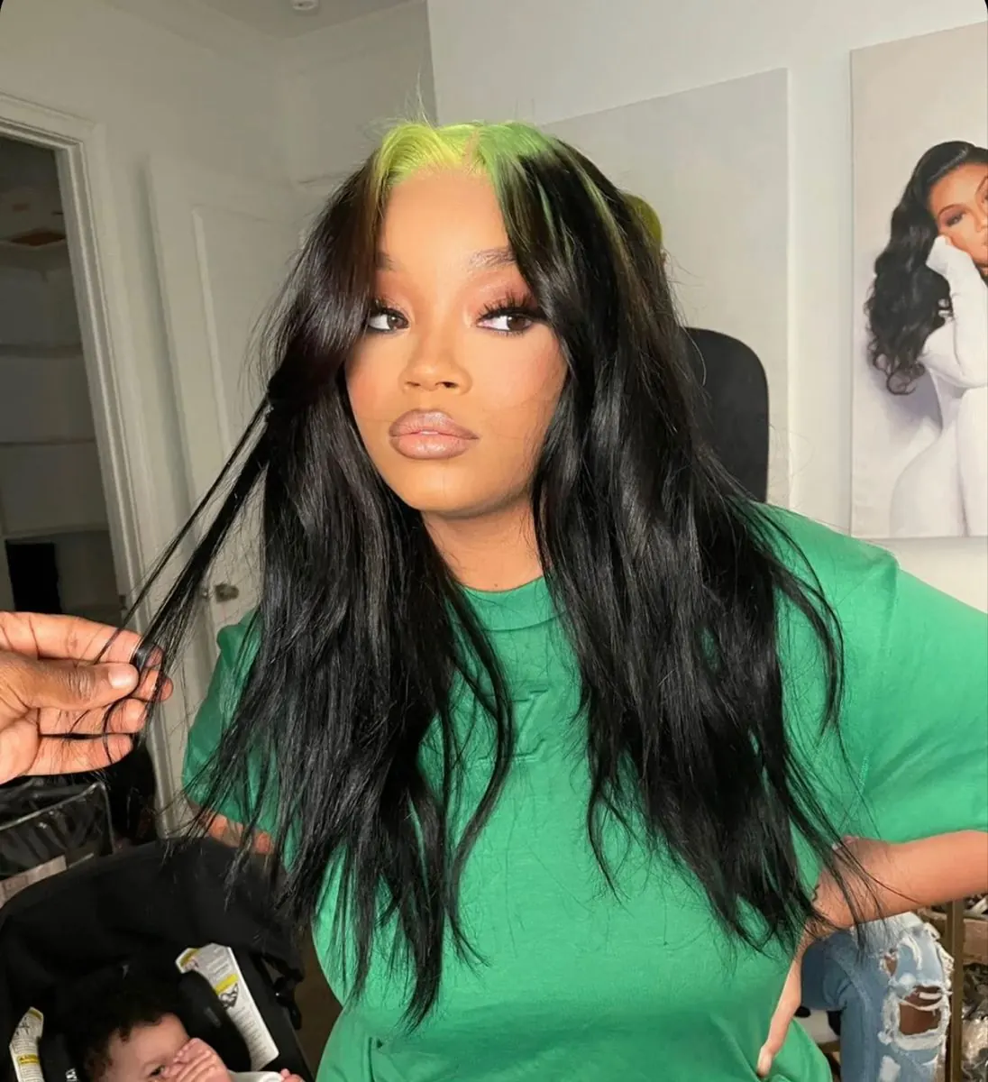 Long black waves with neon green ghost roots and a loose center part.