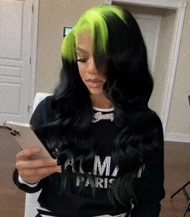 Long black waves with neon chartreuse ghost roots and a clean middle part.