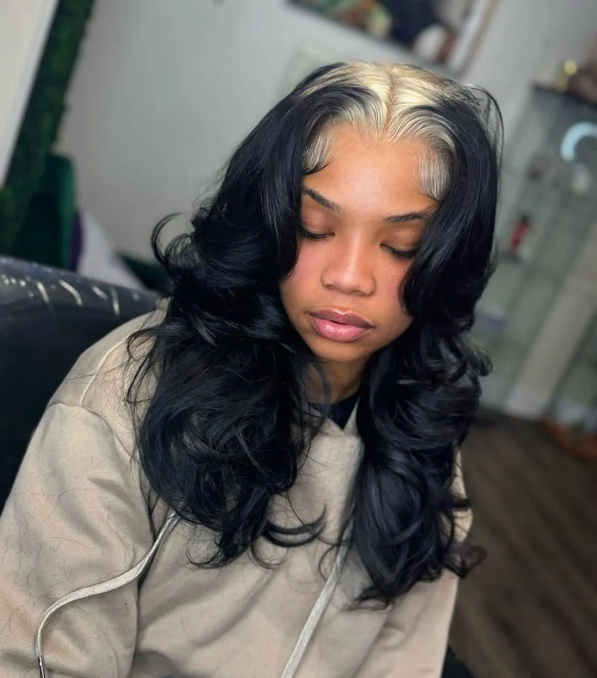 Long dark glam curls with silver white ghost roots around the face.