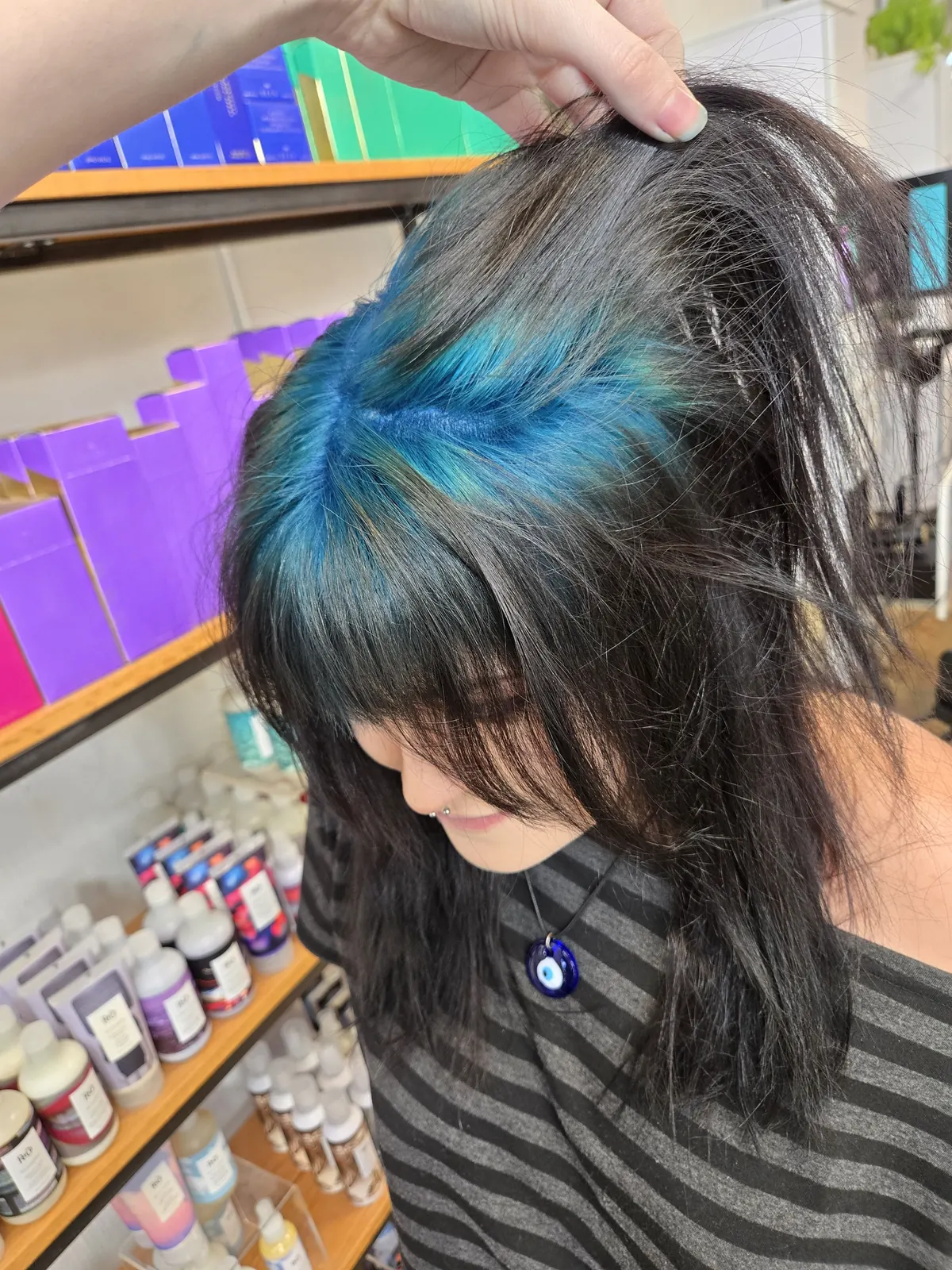 Medium black shag with teal-blue ghost roots through a hidden peekaboo top panel.